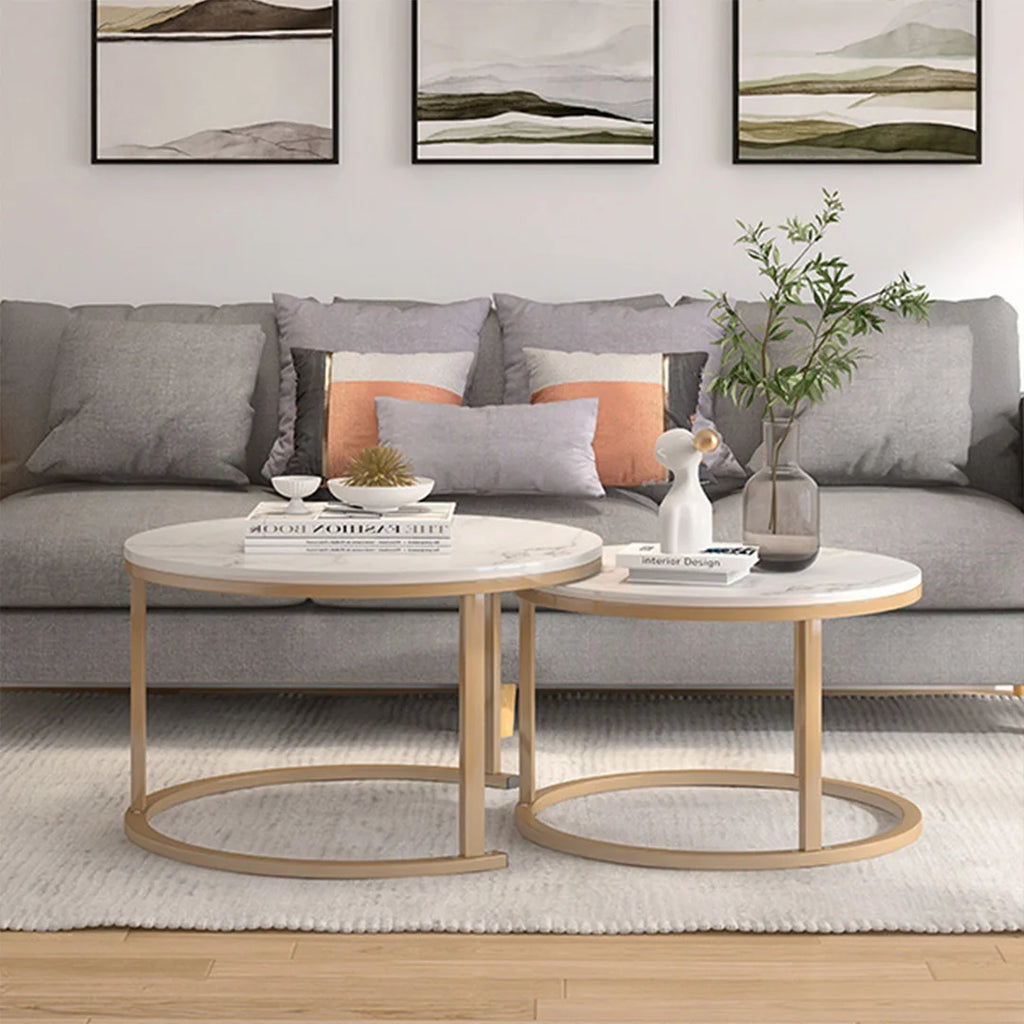 Modern living room with gray sofa, round coffee table, and abstract wall art.