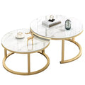 Two round nesting coffee tables with white marble-patterned tops and curved gold metal bases, styled on a clean white background with small decorative objects on top.