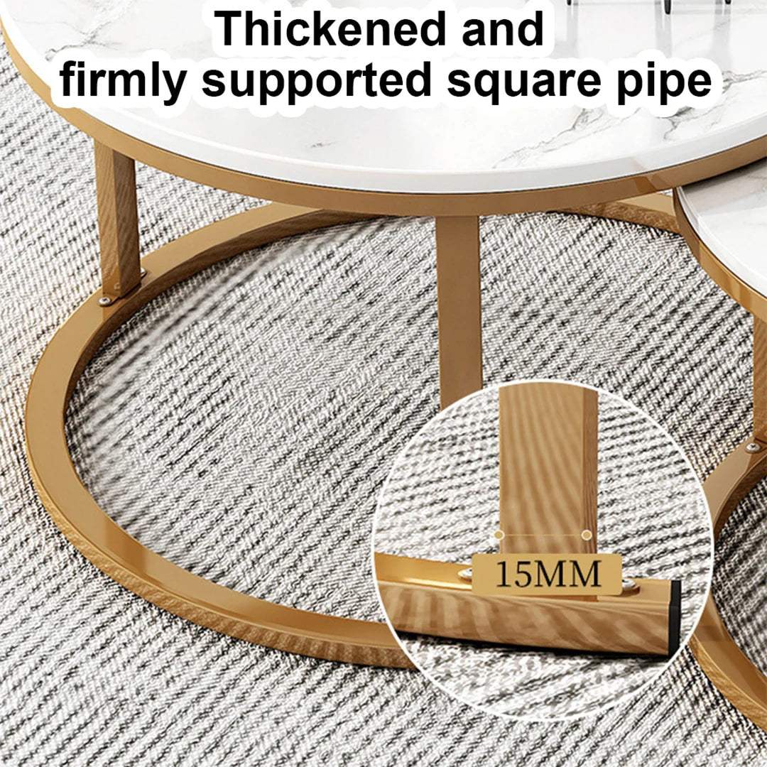 Close-up of a round coffee table with a white marble-look top and gold-toned square metal base, shown over a gray patterned rug. Text reads 'Thickened and firmly supported square pipe,' with a circular inset highlighting a 15MM wood-look support leg detail.
