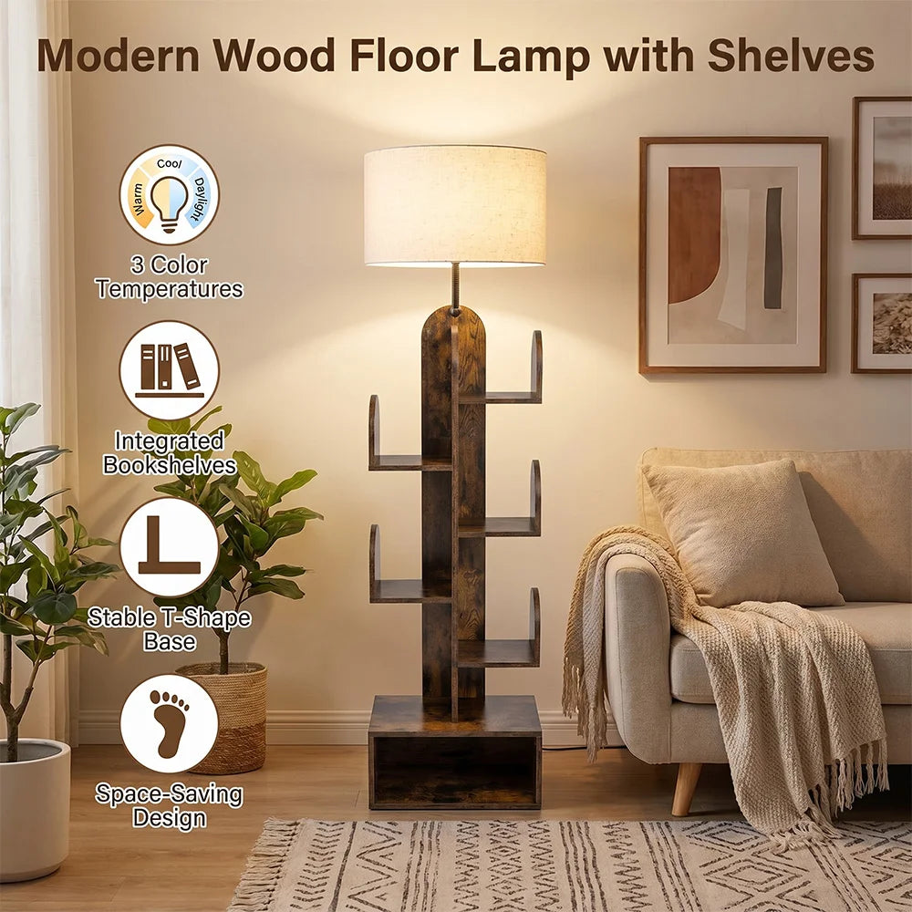 A modern floor lamp with integrated shelves, shown in a styled living room setting. The lamp features a dark brown wood-grain T-shaped base with open shelves, a warm white fabric drum shade, and a slim metallic stem.