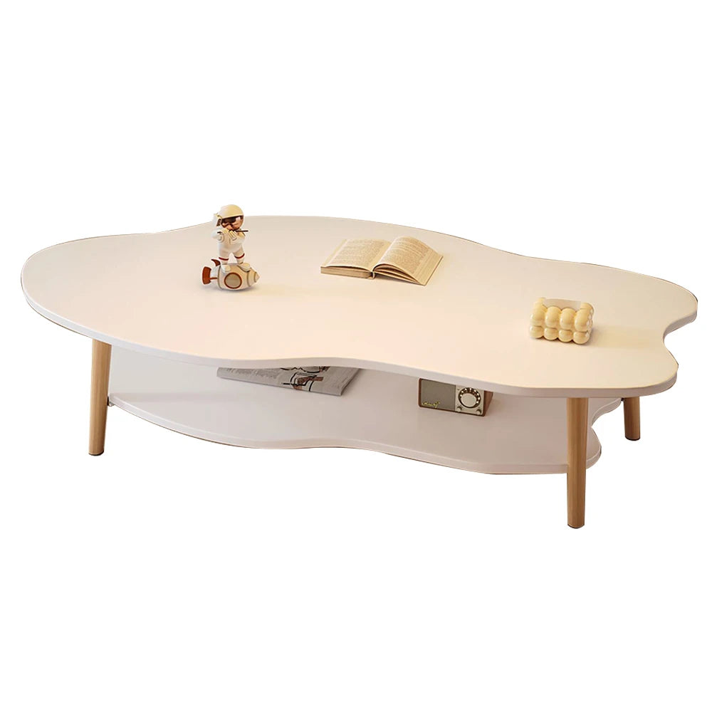 A modern cloud-shaped wooden coffee table with a white top and light natural wood legs, shown on a clean white background with small decorative props on top.
