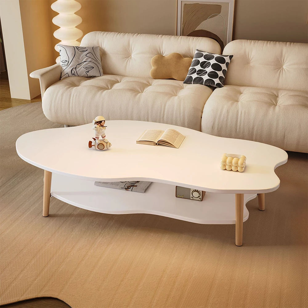 Beige sofa with decorative pillows and a white coffee table in a living room setting.