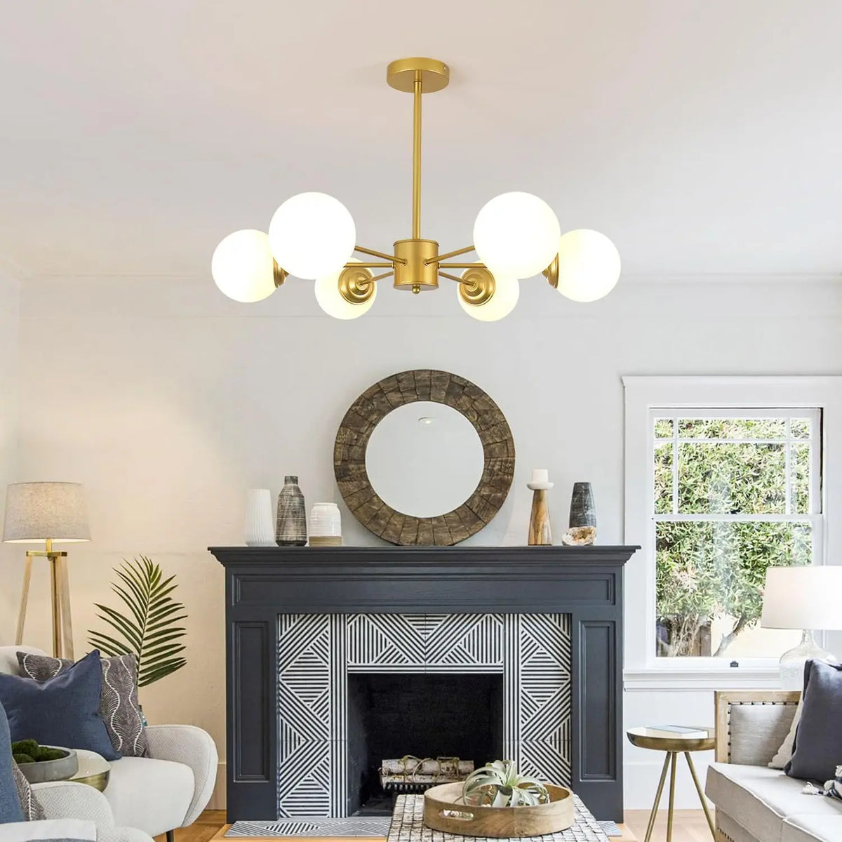 Living room with a fireplace, chandelier, and decorative items.