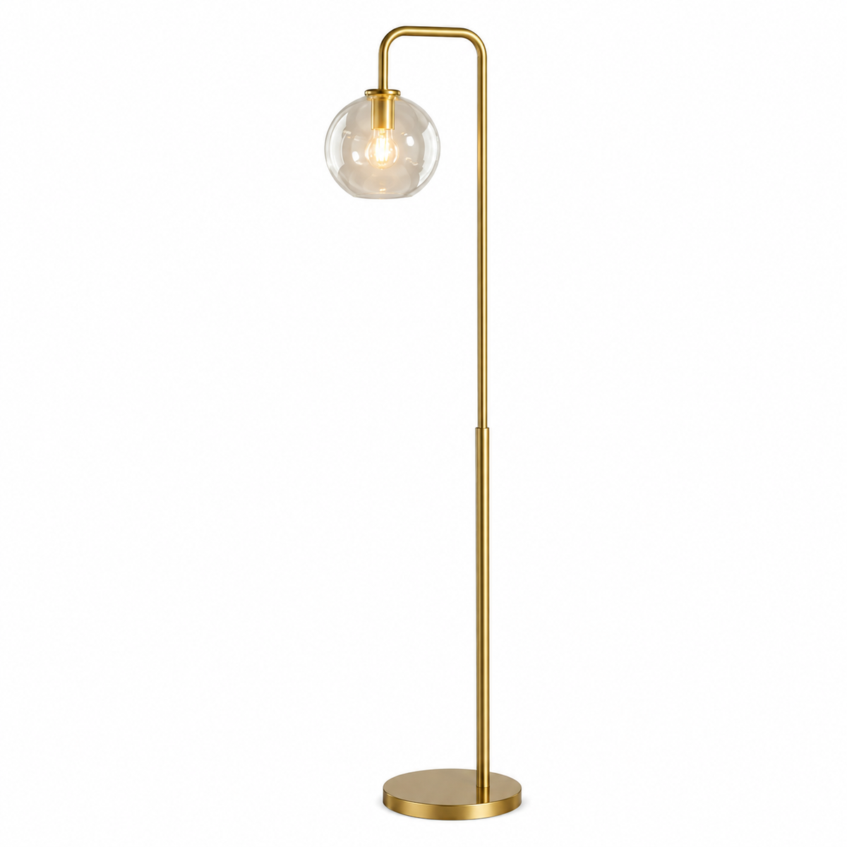 A modern floor lamp with a slim gold-finished metal stand, a curved top arm, and a clear glass globe shade housing a warm glowing bulb, set against a plain white background.