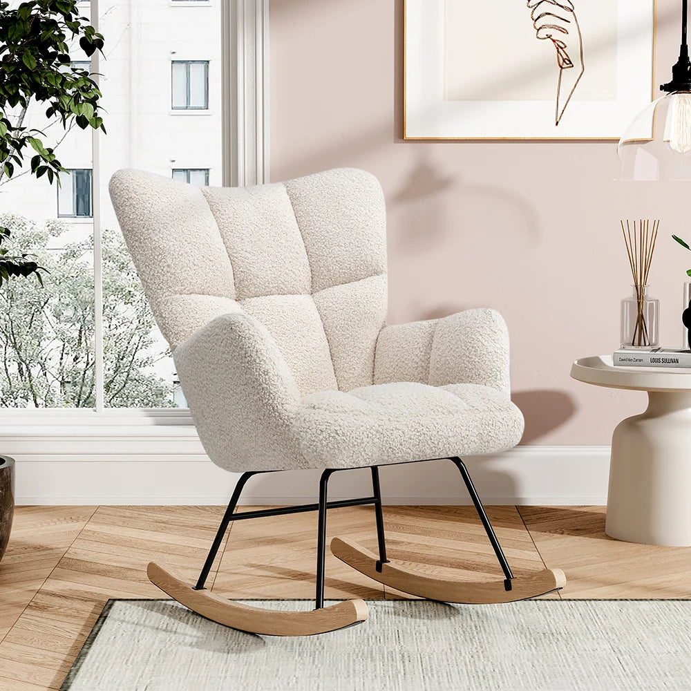 A cream-colored bouclé rocking chair with a high back and black metal rocking legs, placed in a modern living room setting.