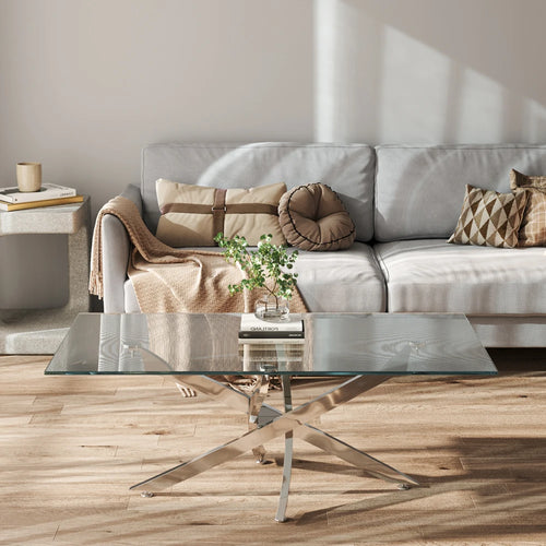 Modern living room with a glass coffee table and gray sofa.