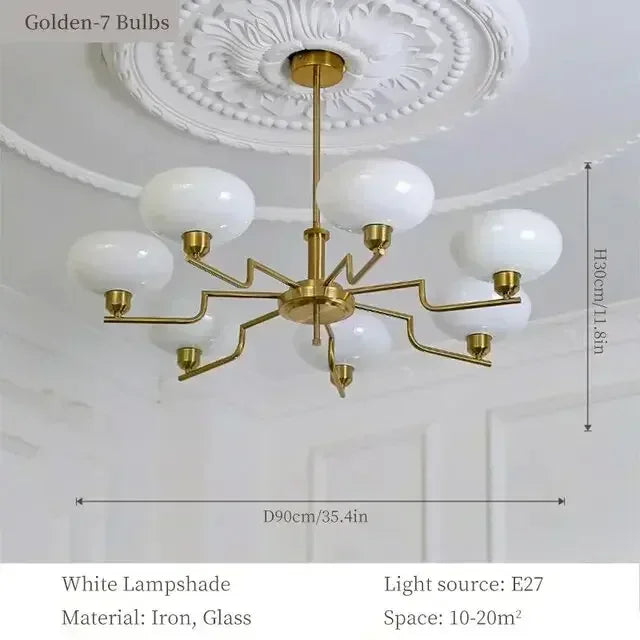 Gold chandelier with white lampshades on a ceiling, showing dimensions and product details.