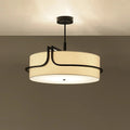 Ceiling light fixture with beige shade and black metal frame on a plain background