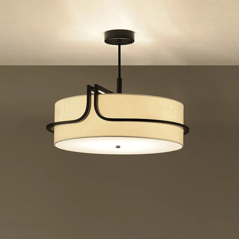 Ceiling light fixture with beige shade and black metal frame on a plain background