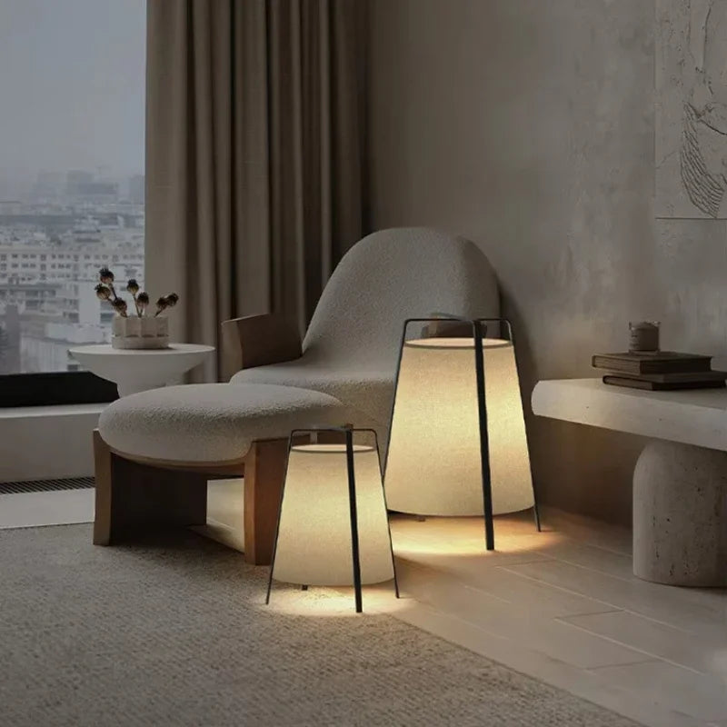 Modern living room with a chair, ottoman, and floor lamp.