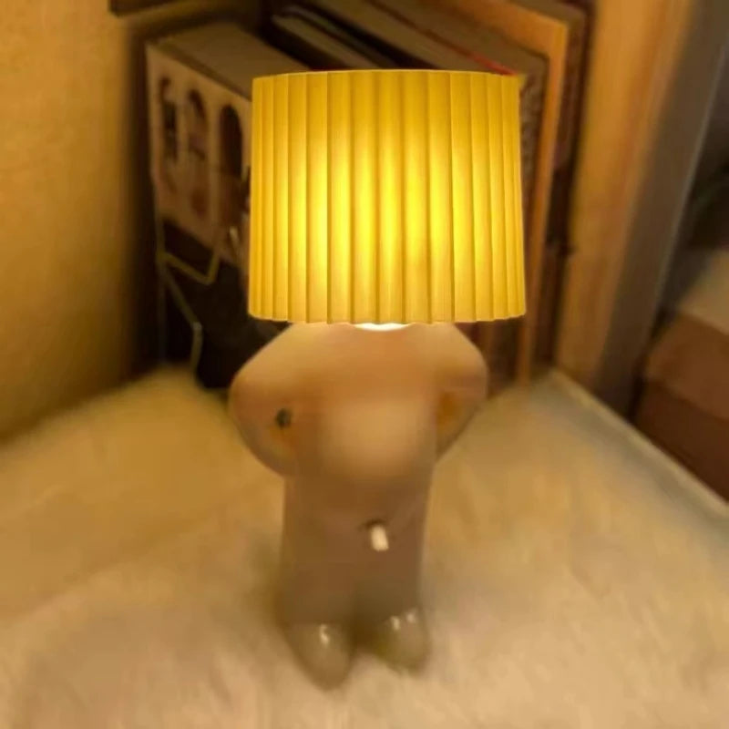 Lamp shaped like a dog with a yellow lampshade on a surface.