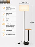 A floor lamp with a tall cylindrical white shade, black metal stand, and a small round wooden side table attached at the base, shown on a light gray background with product specs and dimensions listed on the left.