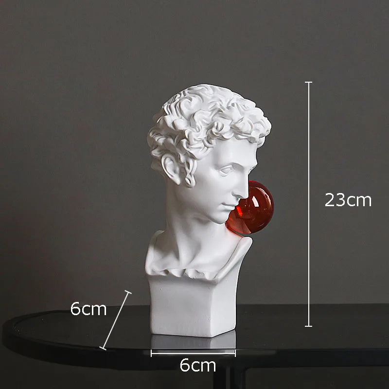 White classical-style bust sculpture light with a red glass orb on its shoulder, shown on a dark tabletop against a gray background with overlaid dimension labels reading 23cm, 6cm, and 6cm.