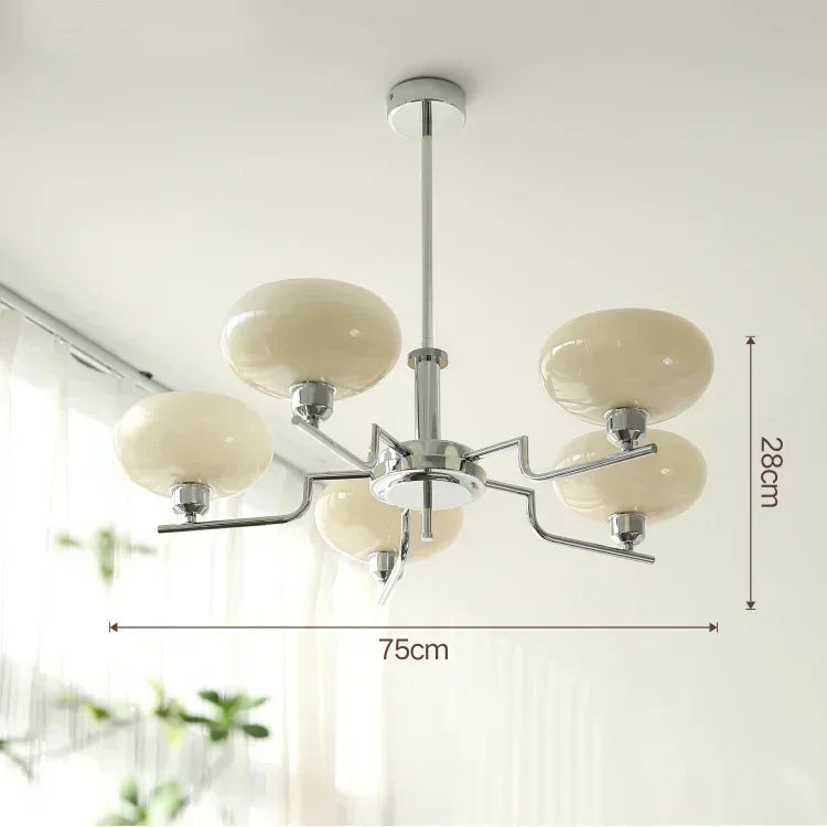 Chandelier with white glass shades and metal fixture on a light background