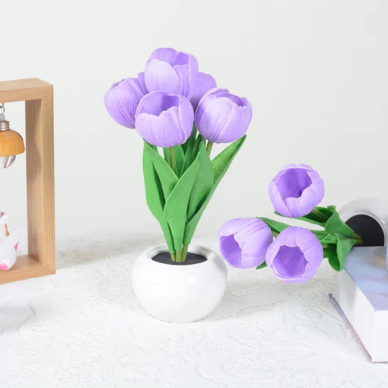 Purple tulips table lamp in a white pot on a light surface with a white background
