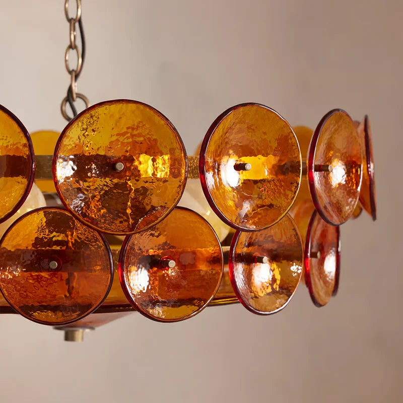 Chandelier with amber glass shades on a neutral background