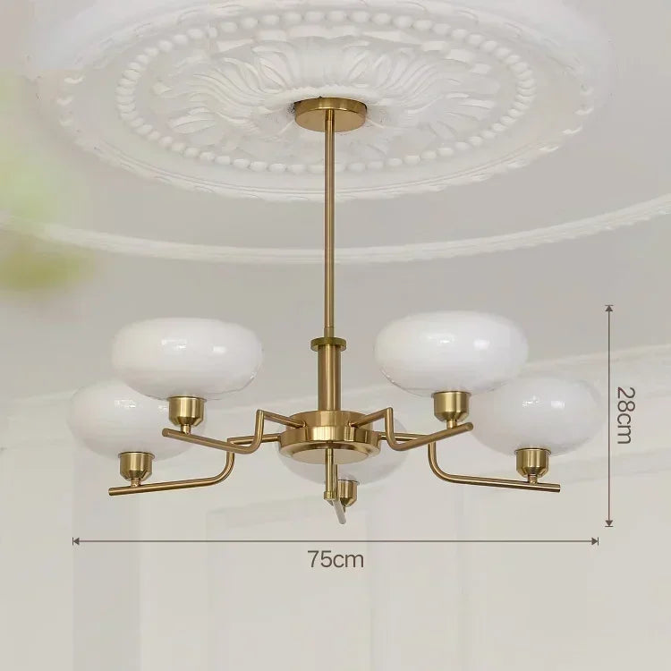 Gold chandelier with white glass shades on a ceiling, showing dimensions.