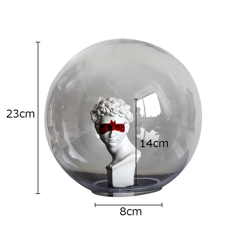 A clear glass globe-style light display dome containing a white classical bust sculpture with a red eye mask, shown on a white background with overlaid dimensions: 23 cm height, 14 cm bust height, and 8 cm base diameter.