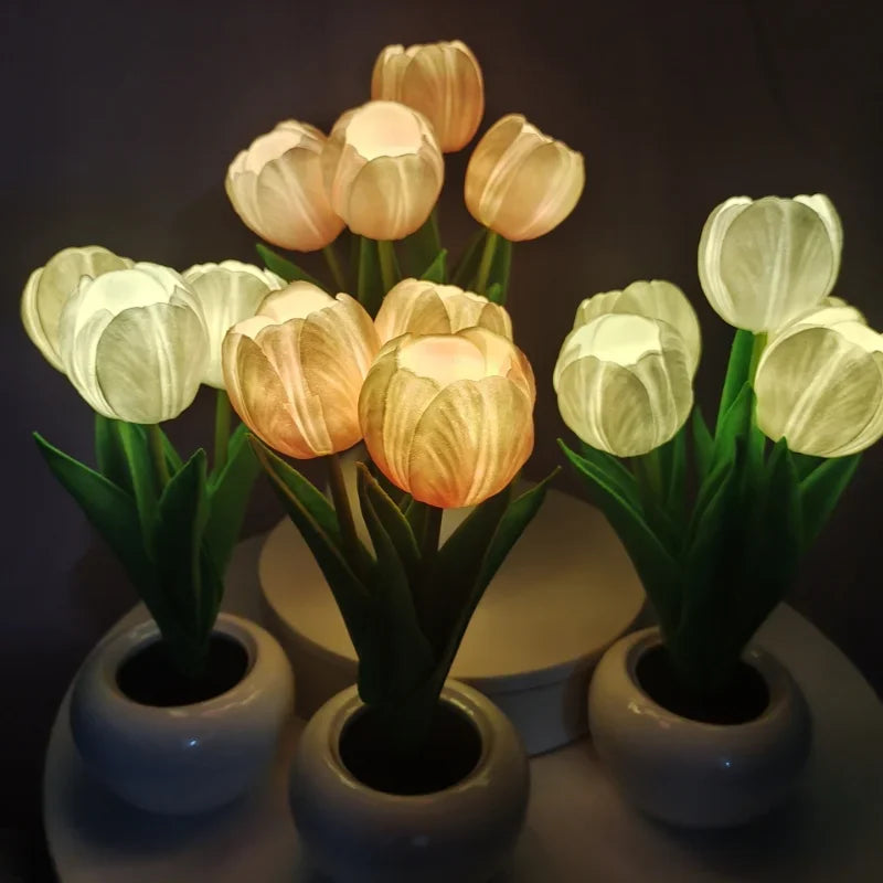 Decorative tulip lights in white pots on a dark background