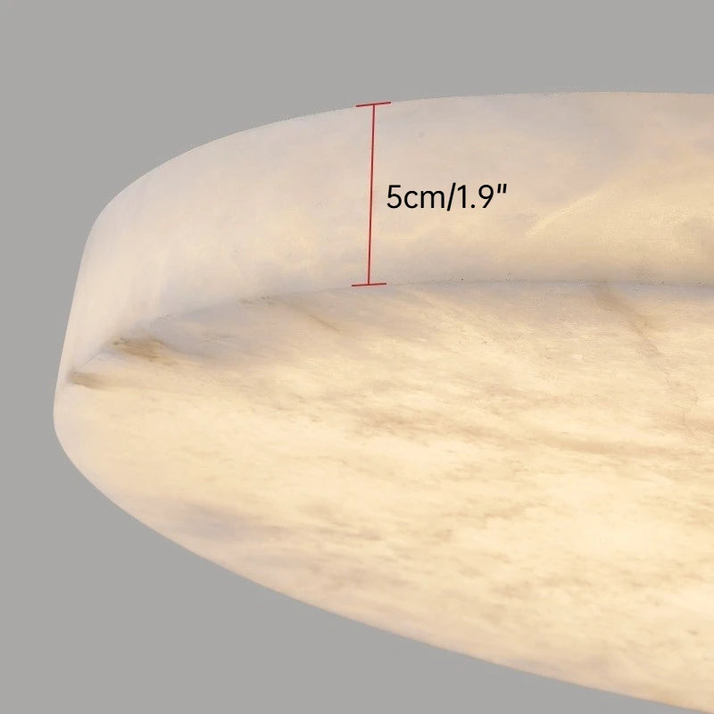 Close-up of a light fixture with a measurement label on a gray background