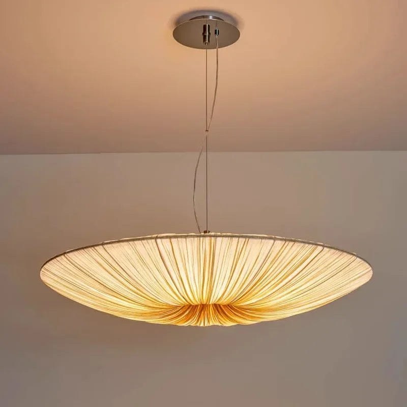 Chandelier hanging from the ceiling with a neutral background