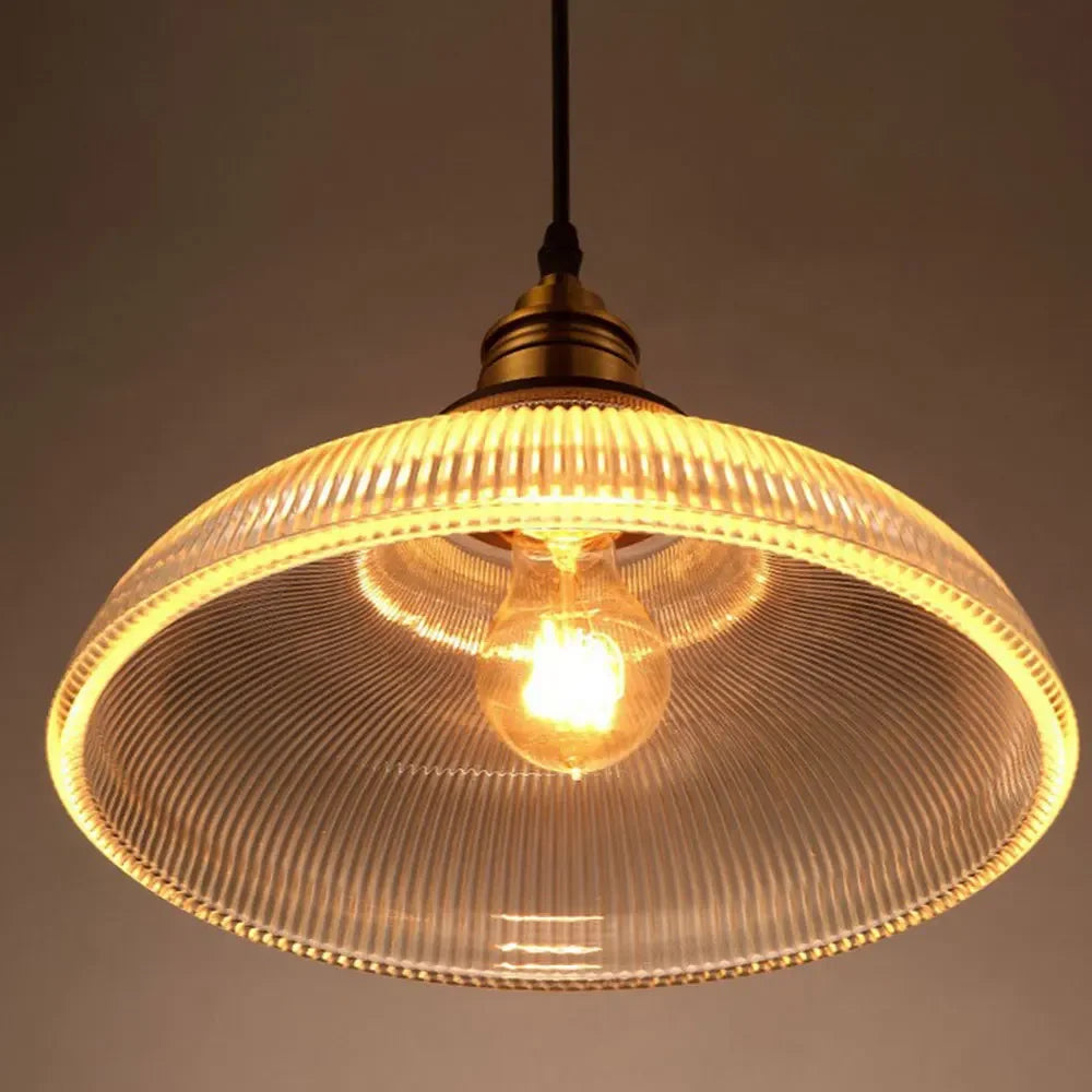 Vintage-style pendant light with ribbed glass shade on a dark background