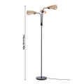 Modern black floor lamp with three woven rattan shades and round base.