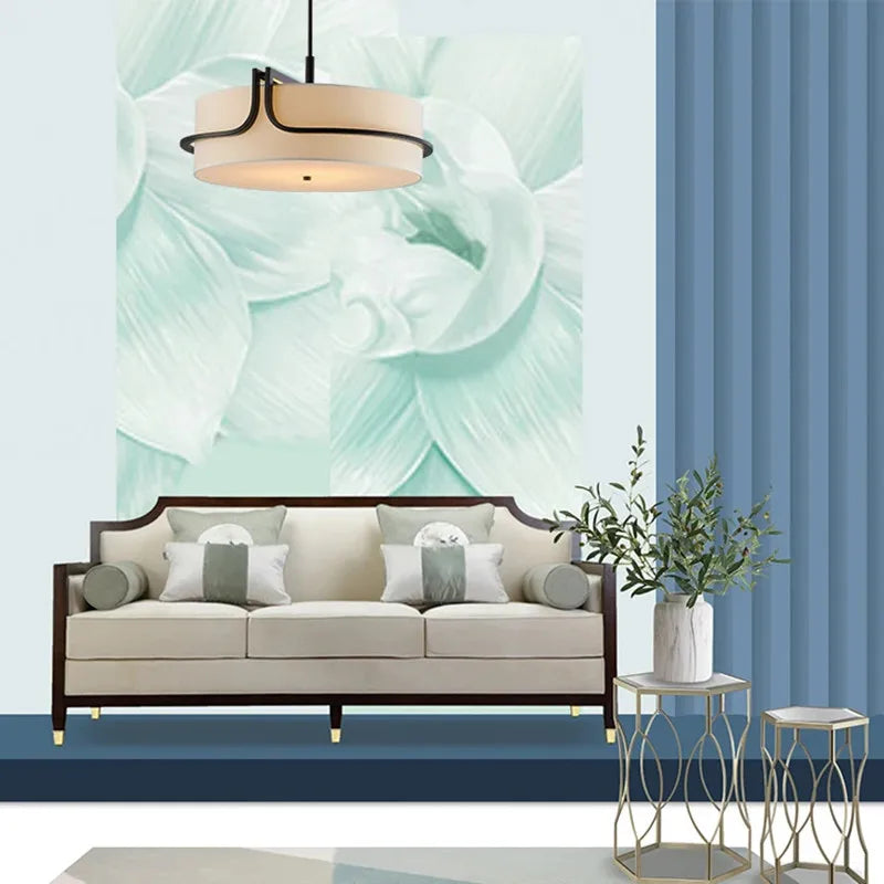Living room with a beige sofa, decorative pillows, and a large abstract wall mural.