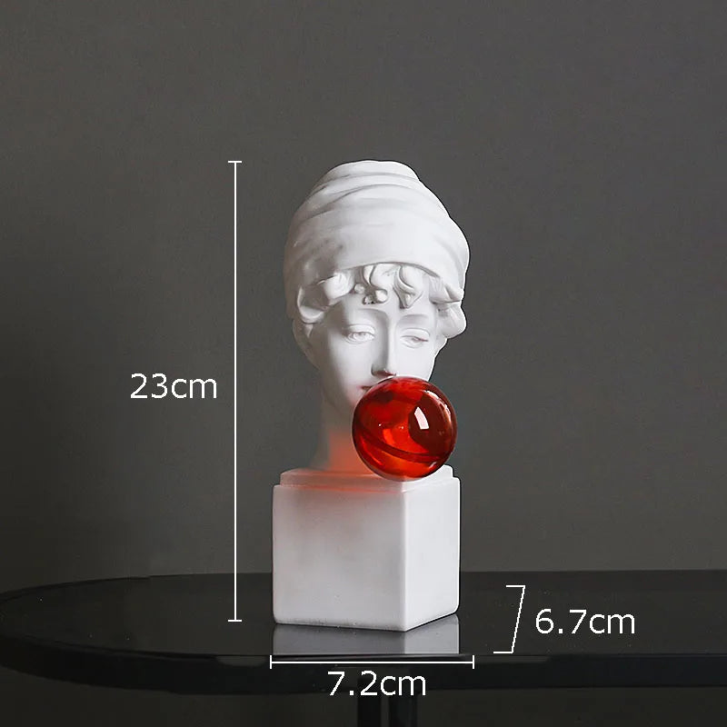 White classical-style bust sculpture light with a red translucent orb resting against the mouth area, shown on a dark reflective surface with overlaid dimension markers reading 23 cm, 7.2 cm, and 6.