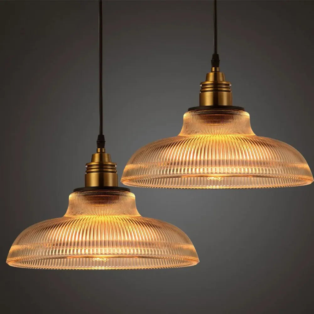 Two vintage-style pendant lights with ribbed glass shades on a dark background