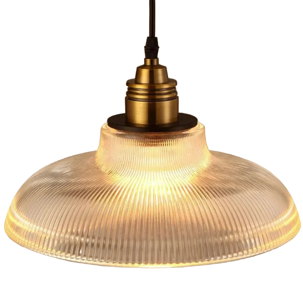 Vintage-style pendant light with ribbed glass shade and brass fitting on a beige background