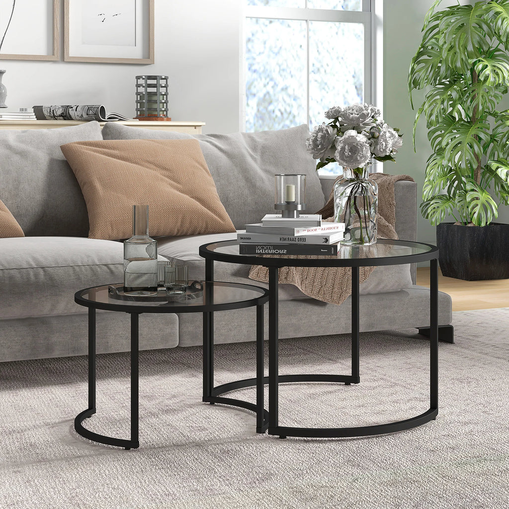 Modern living room with a gray sofa, glass coffee table, and decorative items.