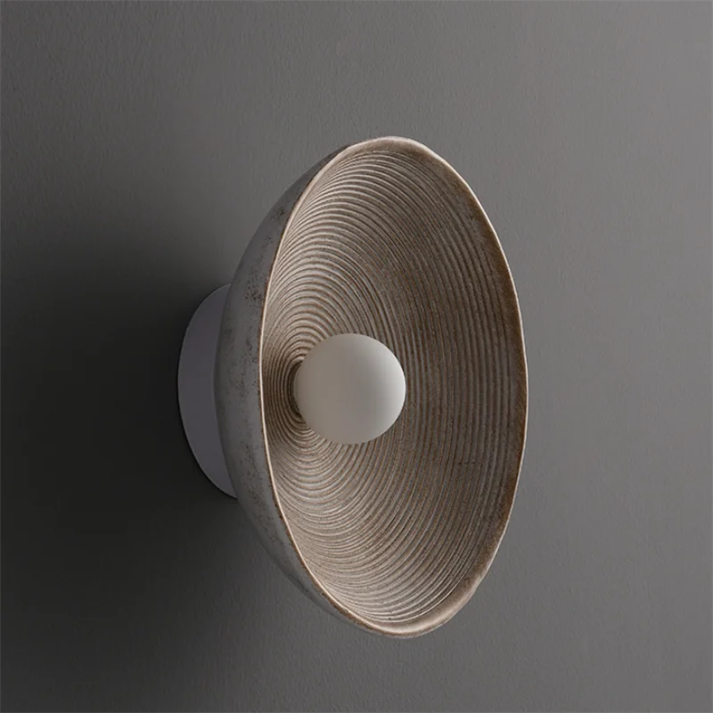 Wall-mounted lamp with textured design on a gray background