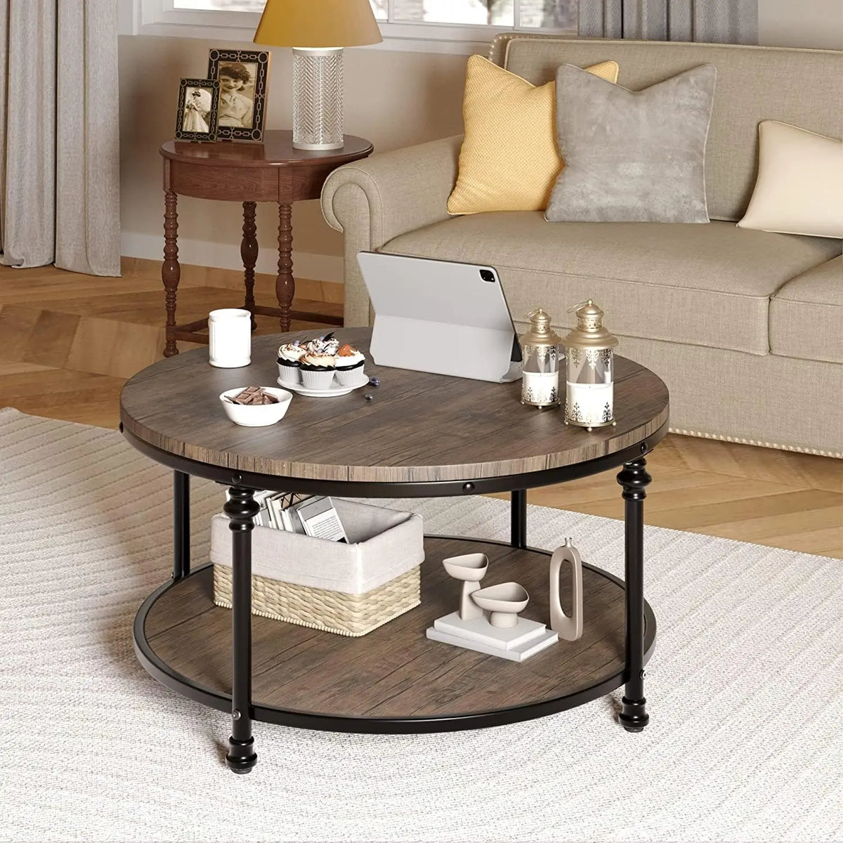 Round wooden coffee table with black metal legs in a living room setting.