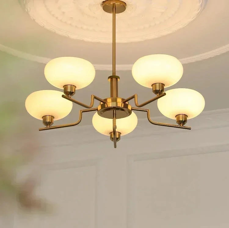 Chandelier with glass shades hanging from a ceiling