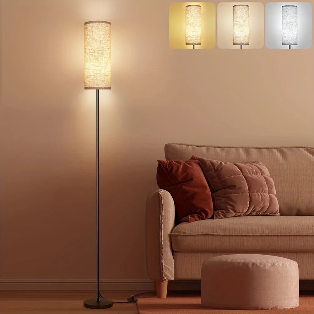 Floor lamp next to a sofa with cushions in a living room setting