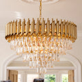 A modern gold chandelier with a circular frame made of vertical brushed metal bars and cascading clear crystal droplets, hanging in an elegant interior room with arched doorways.