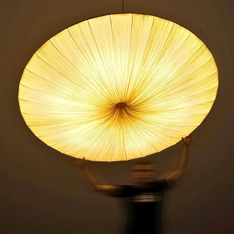 Round lampshade with a warm glow on a dark background