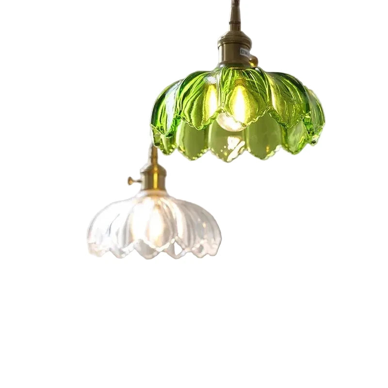 Two vintage-style pendant lights with green and clear glass shades on a white background.