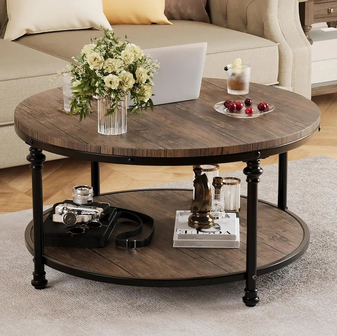 Round wooden coffee table with decorative items in a living room setting