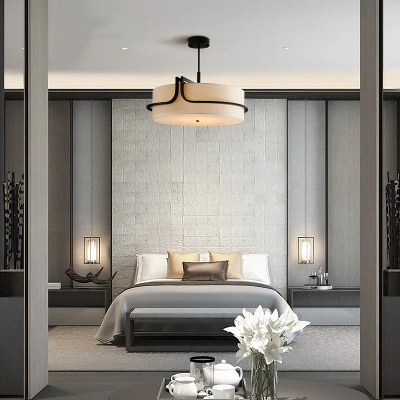 Modern bedroom with a bed, lamp, and decor elements.