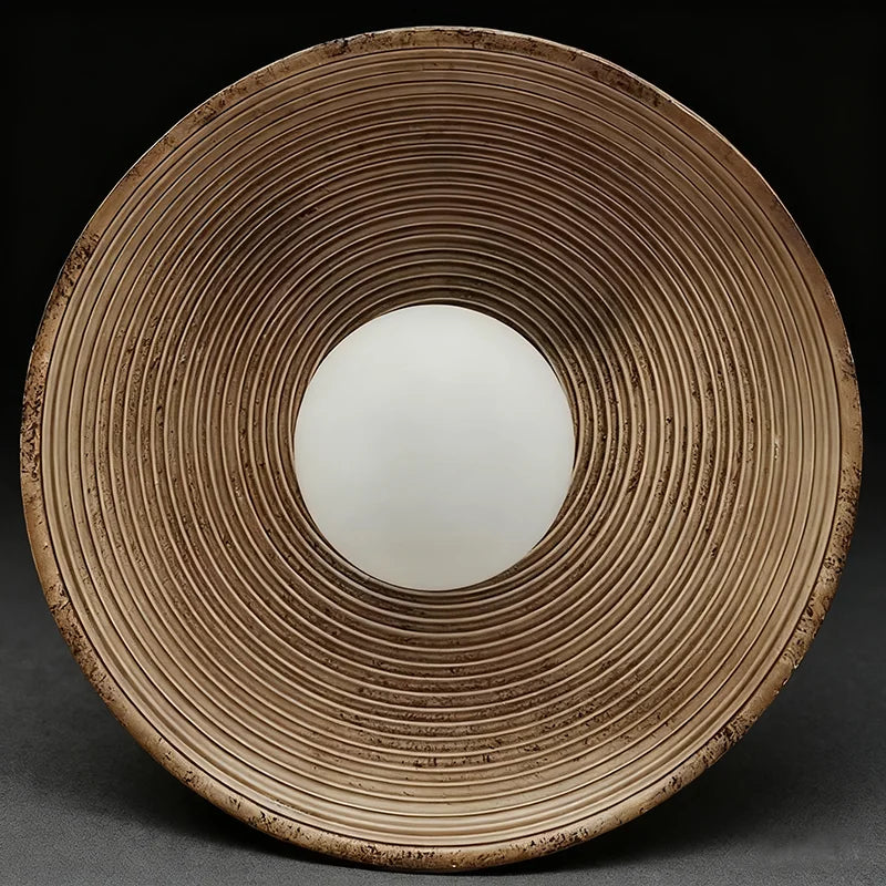 Round ceramic plate with textured rim on a dark background