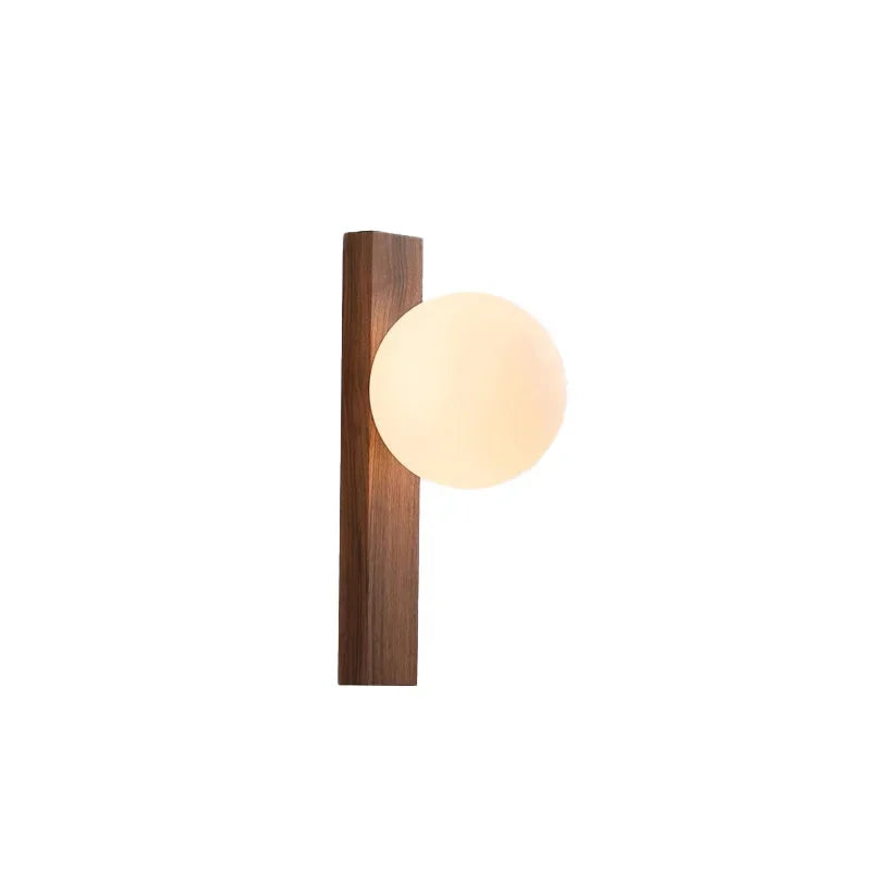 Wall-mounted light fixture with wooden base and glass globe on a white background