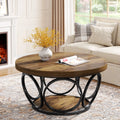 Wooden coffee table with black metal base in a living room setting.