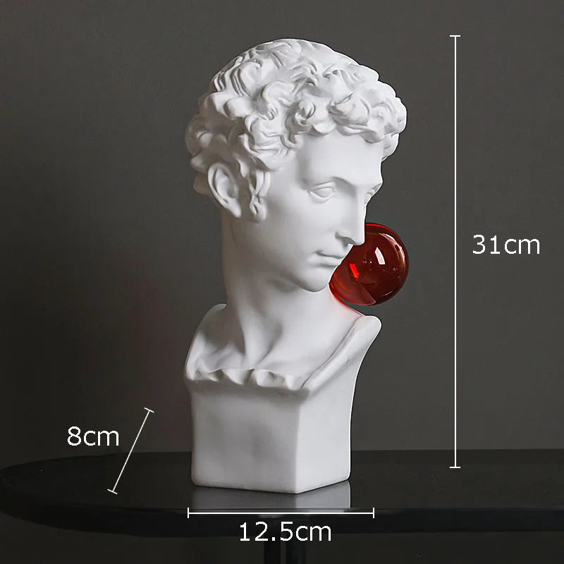 White classical-style male bust sculpture light with a red translucent sphere protruding from the nose, shown on a dark surface against a dark gray background with overlaid dimensions: 31 cm height, 12.5 cm base width, and 8 cm sphere width.