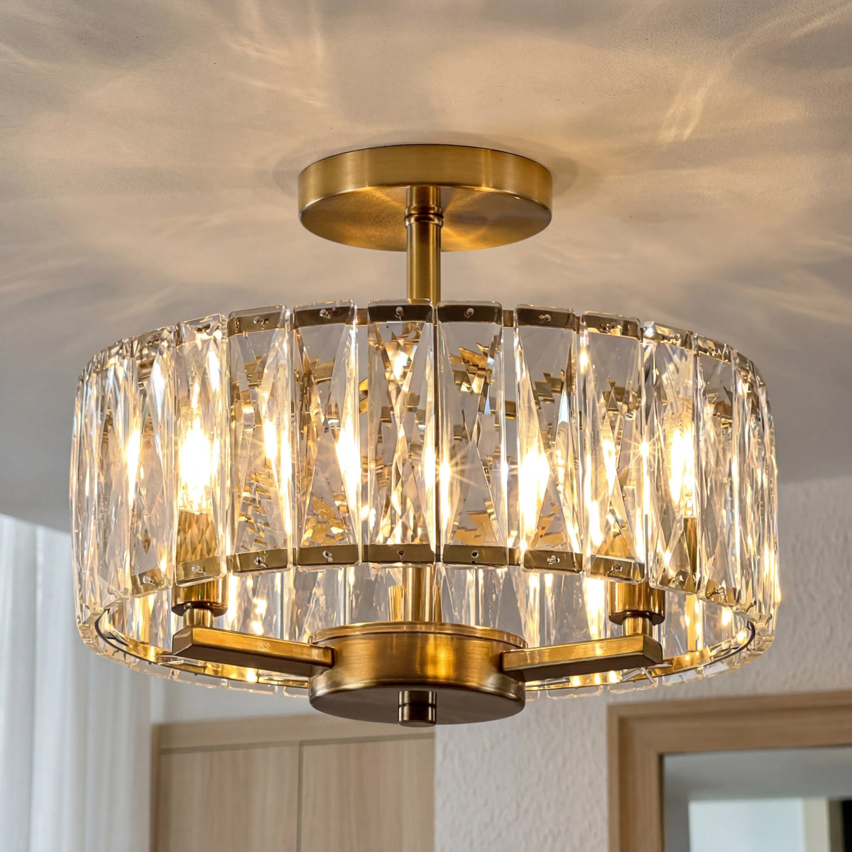 Gold and crystal ceiling light fixture on a neutral background