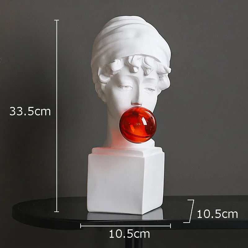 White classical-style bust sculpture light with a red translucent bubble on its lips, shown on a black round table against a dark gray background with overlaid dimension lines and labels.