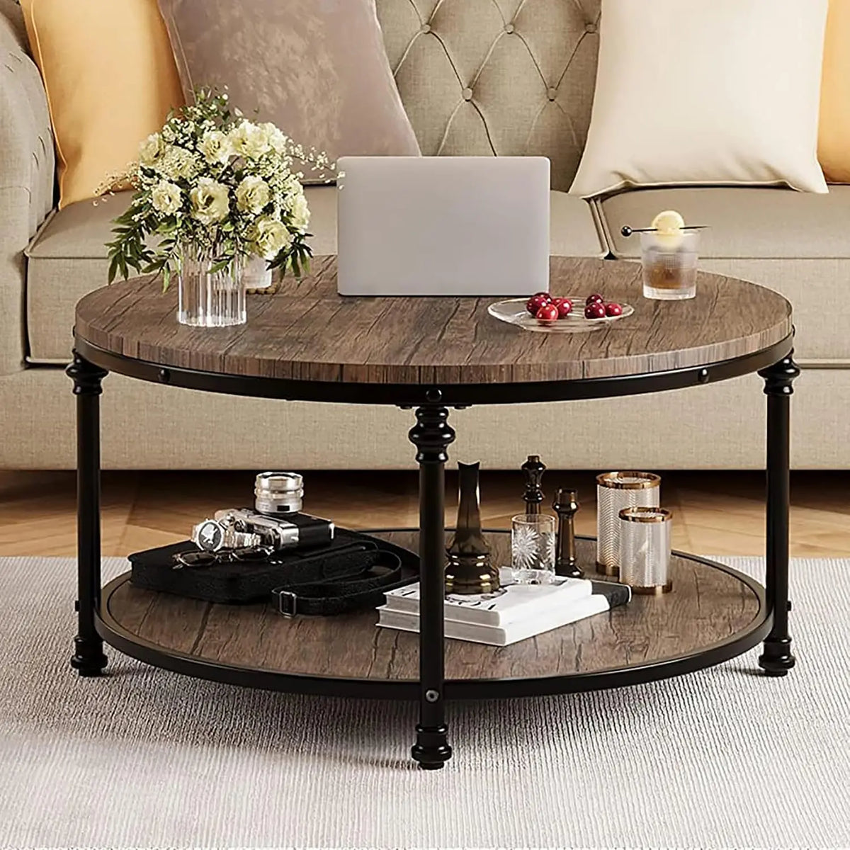 Round wooden coffee table with decorative items in a living room setting