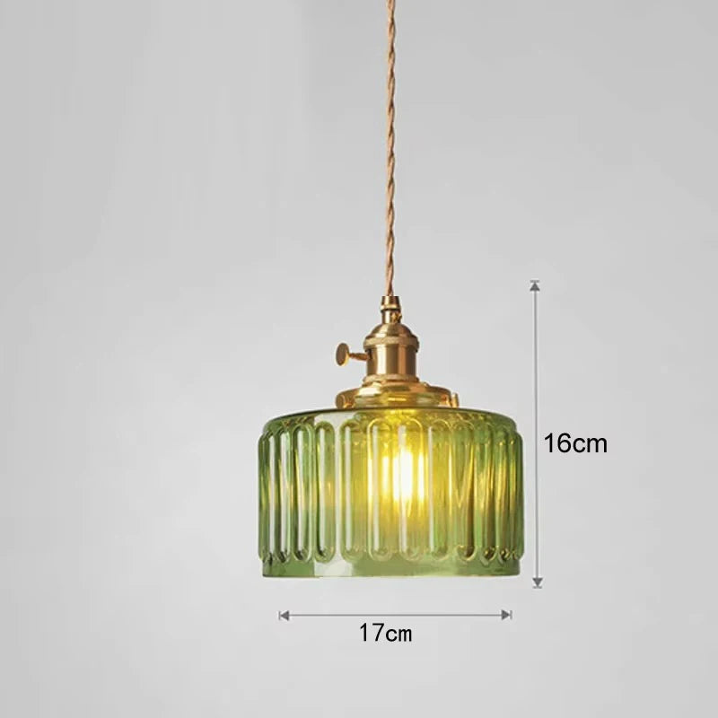 Green glass pendant light with gold fixture on a gray background, showing dimensions.