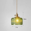 Green glass pendant light with gold fixture on a gray background, showing dimensions.